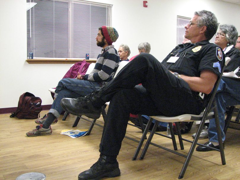 Spokane Police Sergent Dennis Walter and Brian Estes of the South Perry Farmers Market listen to Mayor Mary Verner's presentation at the South Perry Business and Neighborhood Association's annual meeting on Oct. 12. The meeting was held at the Emmanuel Life Center. (Pia Hallenberg)