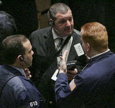
Traders work at a station at the New York Stock Exchange. The SEC approved rules designed to protect investors by requiring traders to accept the best quoted price for any transaction.
 (Associated Press / The Spokesman-Review)