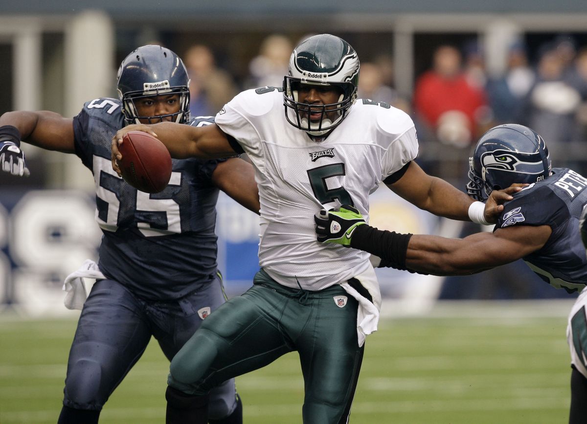 Eagles quarterback Donovan McNabb tries to get away from Seattle’s Darryl Tapp, left, and Julian Peterson. (Associated Press / The Spokesman-Review)