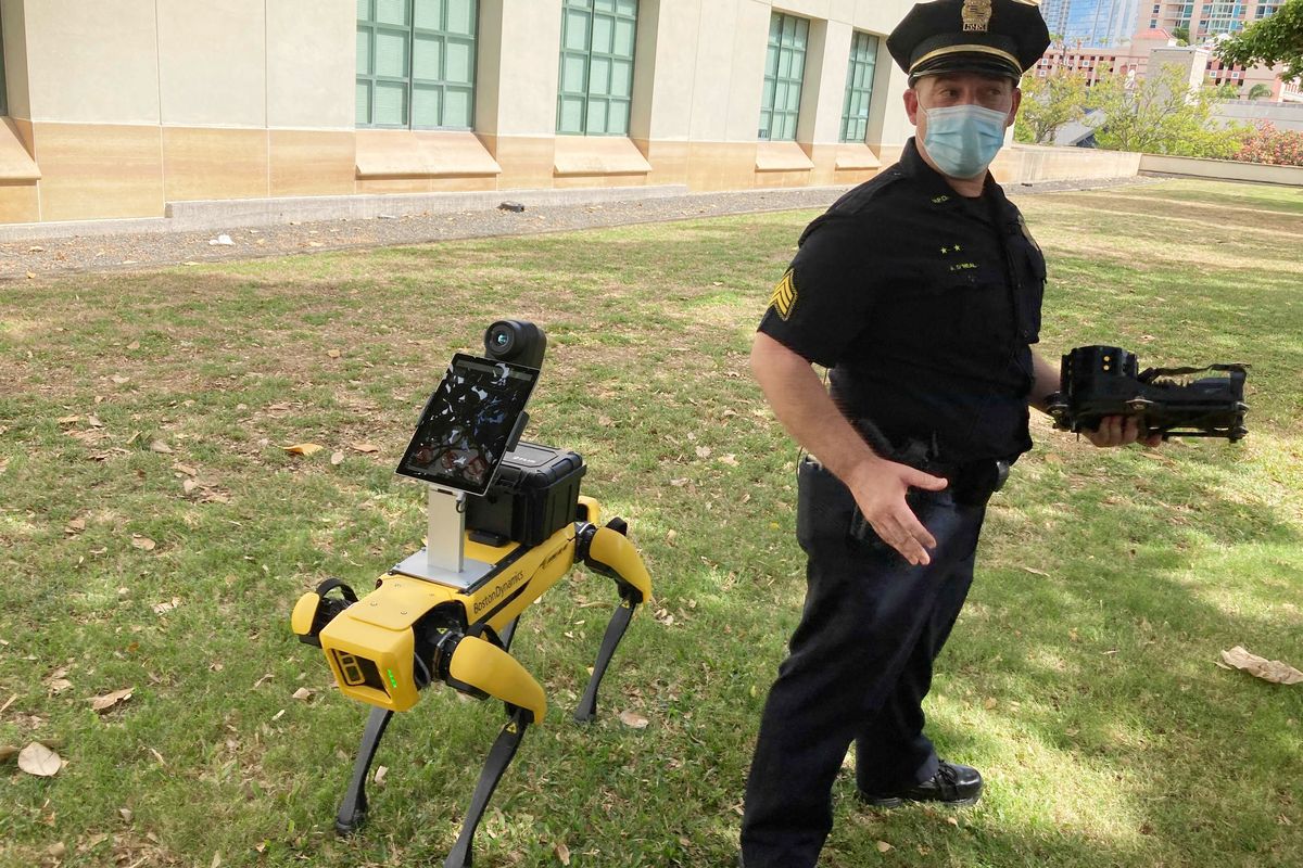 Honolulu Police Acting Lt. Joseph O’Neal demonstrates a robotic dog in Honolulu on May 14. Police officials experimenting with the four-legged machines say they’re just another safety tool for first responders.  (Jennifer Sinco Kelleher)