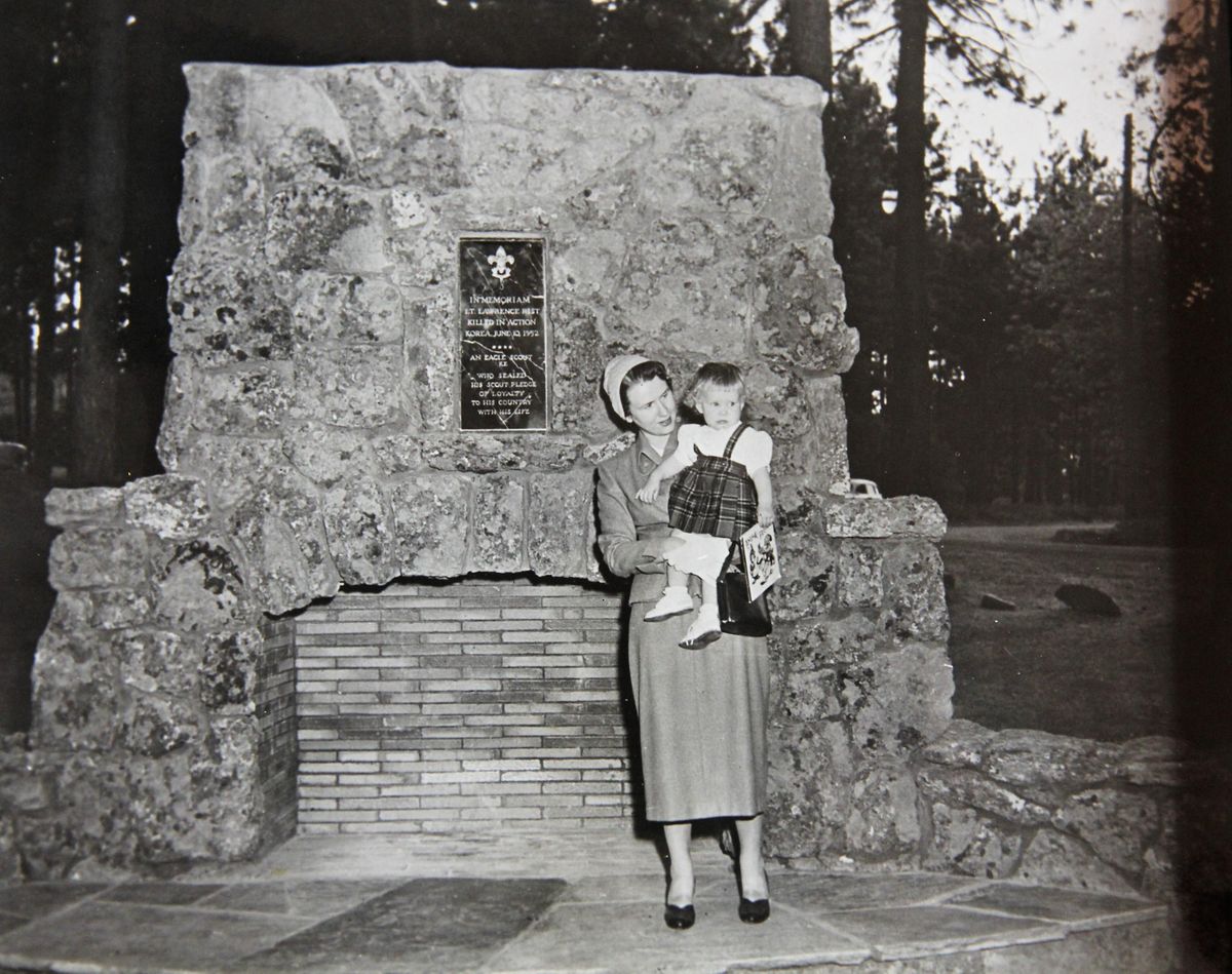 LaVar Rist holding her young daughter Andrea in 1953 at the memorial fireplace dedicated to her husband Lawrence Rist, who had been killed in the Korean War. It was a project of Boy Scout Troop 4 in honor of Rist, their scout master. (Courtesy of Andrea Matters)