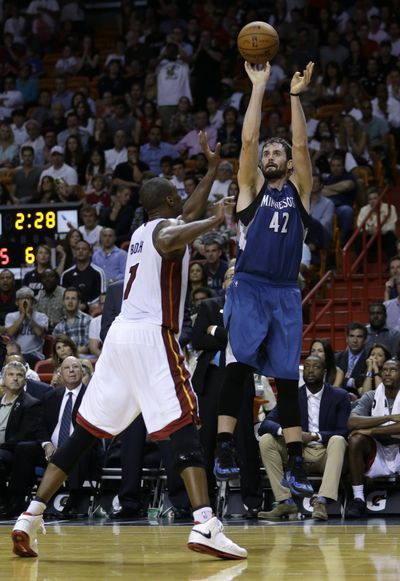 Minnesota Timberwolves forward Kevin Love scored 28 points and grabbed 11 rebounds in a 122-121 double-overtime win over Miami. (Associated Press)