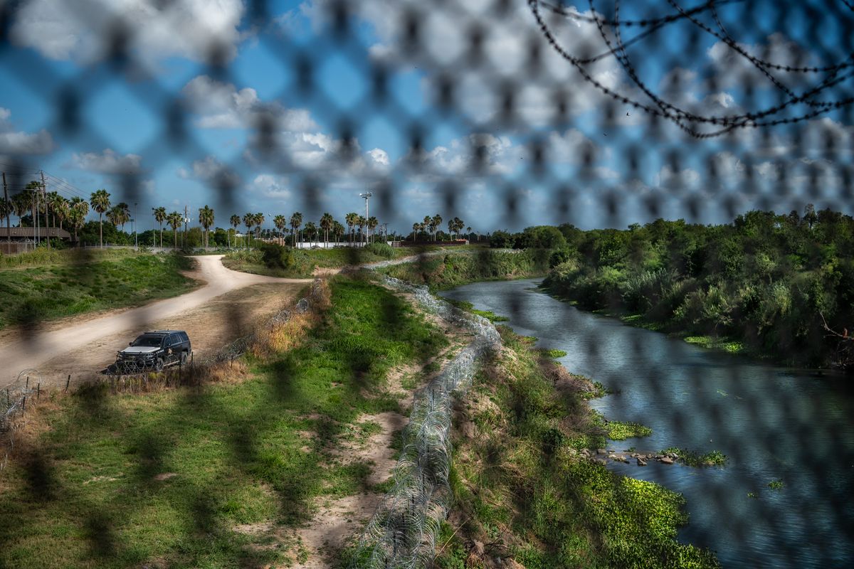 Coils of barbed wire were recently placed on the northern shore of the Rio Grande, which separates Brownsville, Tex., and Matamoros, Mexico.    (Meridith Kohut/For The Washington Post)