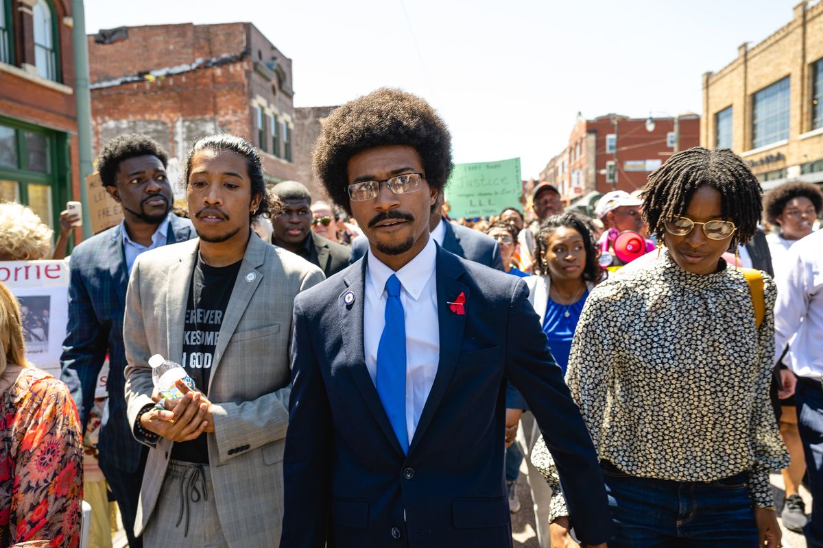 State Rep. Justin J. Pearson, center, who was briefly ousted from the Legislature by the GOP, marches with State Rep. Justin Jones, left, in Memphis, Tenn., on April 12.  (JON CHERRY)