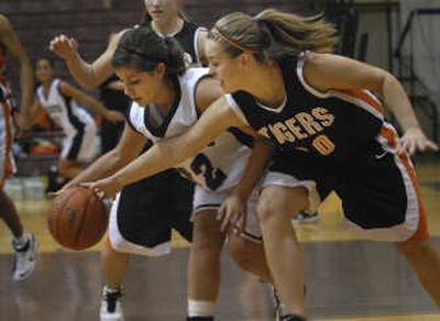 
Lewis and Clark's Mary Blevins, right, goes for a steal against Mt. Spokane's Kelsey Baker in a Greater Spokane League opener Tuesday.
 (Brian Plonka / The Spokesman-Review)