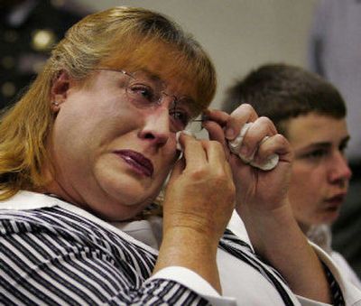 
Lisa Sorger, left, and her son, Keith, listen as Lisa's  statement about her murdered son, Craig, is read during Evan Savoie's  sentencing. 
 (Associated Press photos / The Spokesman-Review)