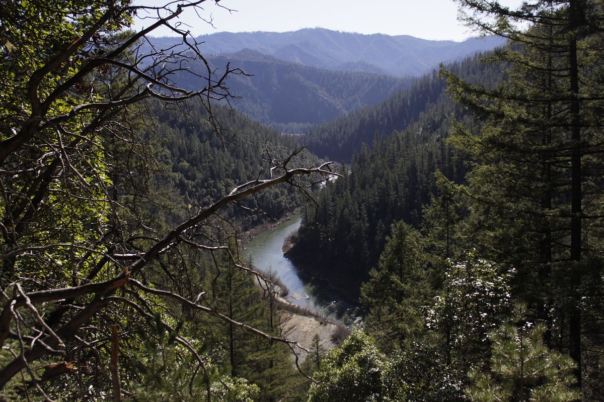 FILE - In this March 3, 2020, file photo, the Klamath River is seen flowing across northern California from atop Cade Mountain in the Klamath National Forest. Federal regulators on Thursday, July 16, 2020, threw a significant curveball at a coalition that has been planning for years to demolish four massive hydroelectric dams on a river along the Oregon-California border to save salmon.  (Gillian Flaccus)