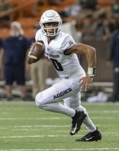 In this Saturday, Nov. 3, 2018 photo, Utah State quarterback Jordan Love rolls out looking for an open receiver in the first half of an NCAA college football game against Hawaii in Honolulu. Love, who posted big numbers a season ago, is now being hyped for the Heisman Trophy. (Eugene Tanner / Associated Press)