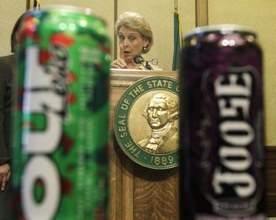 Washington Gov. Chris Gregoire talks about the decision to ban alcoholic energy drinks, such as those pictured in the foreground, Wednesday, Nov. 10, 2010, at the Capitol in Olympia. (Ted S. Warren / Associated Press)
