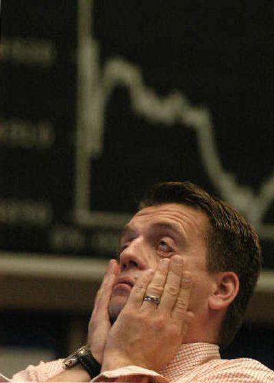 
A stock trader reacts in front of the German Stock Index displayed at the stock exchange in Frankfurt, Germany.
 (Associated Press / The Spokesman-Review)