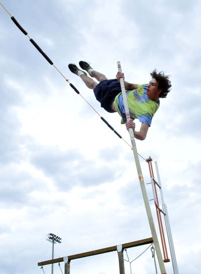 Jay Alexander flies toward a bungee cord stretched across the pit during pole vault practice Monday at University High School. Alexander competed Thursday in the state track meet in Tacoma and cleared 14-0 to finish in third place. (Jesse Tinsley)