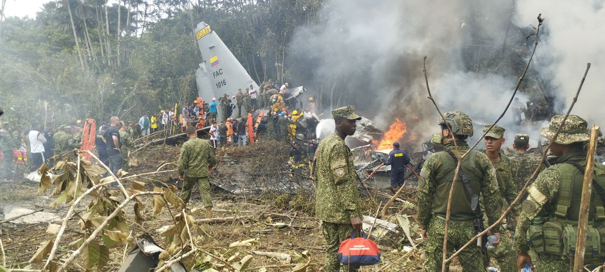 Members of the military gather Monday at the site of a Colombian military plane crash in Puerto Leguizamo, Putumayo, Colombia.  (Reuters )