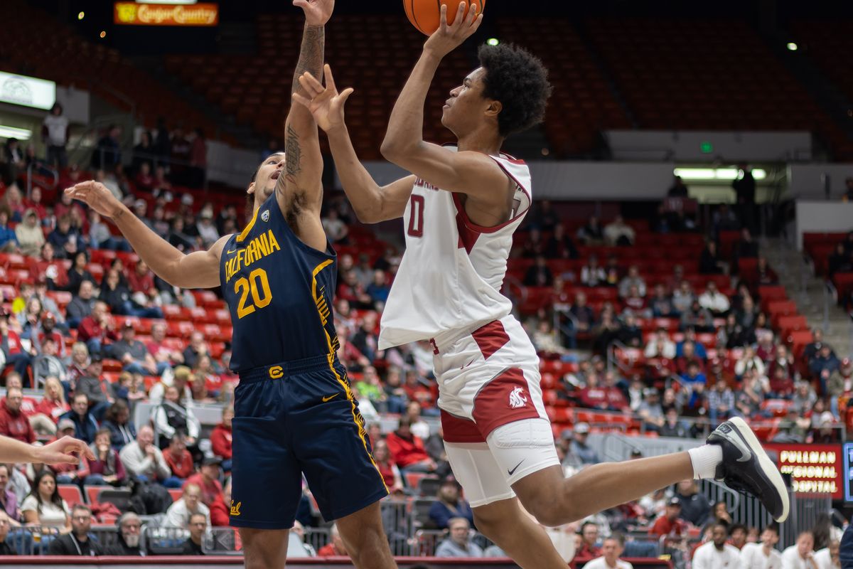 Washington State’s Jaylen Wells, right, puts up a shot against California’s Jaylon Tyson in the first half Thursday at Beasley Coliseum in Pullman.  (Geoff Crimmins/For The Spokesman-Review)