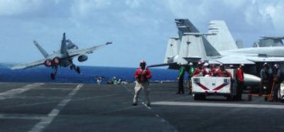
An F/A-18 Hornet launches off the flight deck of the USS Ronald Reagan on Monday during maneuvers in the Pacific Ocean. Three U.S. aircraft carriers filled the skies near Guam with fighters Tuesday during one of the largest U.S. military exercises in decades. 
 (Associated Press / The Spokesman-Review)