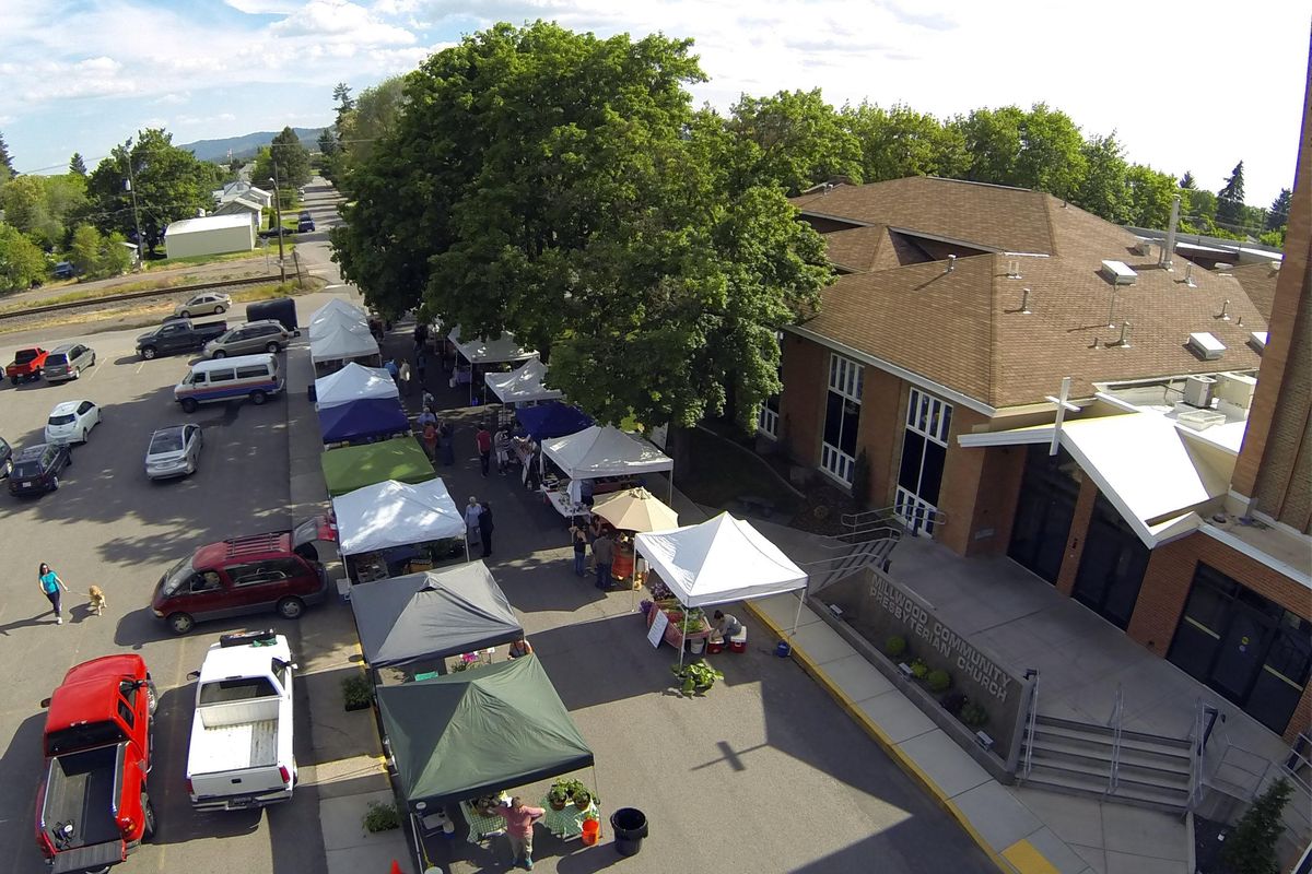 The stalls of the Millwood farmers market  line Marguerite Road on June 4, 2014. The stalls moved from a parking lot, offering easier parking for shoppers and shade. (Jesse Tinsley / The Spokesman-Review)