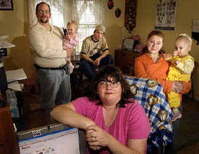 Sherry Willis, center, and her family were lured by the promise of a low monthly rate for unlimited domestic calls, but soon found the plan had limitations. (Associated Press / The Spokesman-Review)