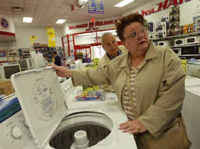 
With husband Frank at her side, Ann Monforte quizzes a salesperson while looking to purchase a washing machine in Brooklyn.
 (Associated Press / The Spokesman-Review)