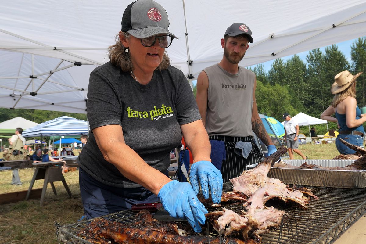 Chef Tamara Murphy of Terra Plata in Seattle prepares goat for her dish at Burning Beast. Murphy organizes the event, which features chefs preparing different "beasts" cooked over open fires. (John Nelson)