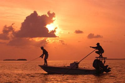
A fishing guide identifies a casting target for his customer while fishing on the flats off Islamorada, Fla., in the Florida Keys.
 (The Spokesman-Review)