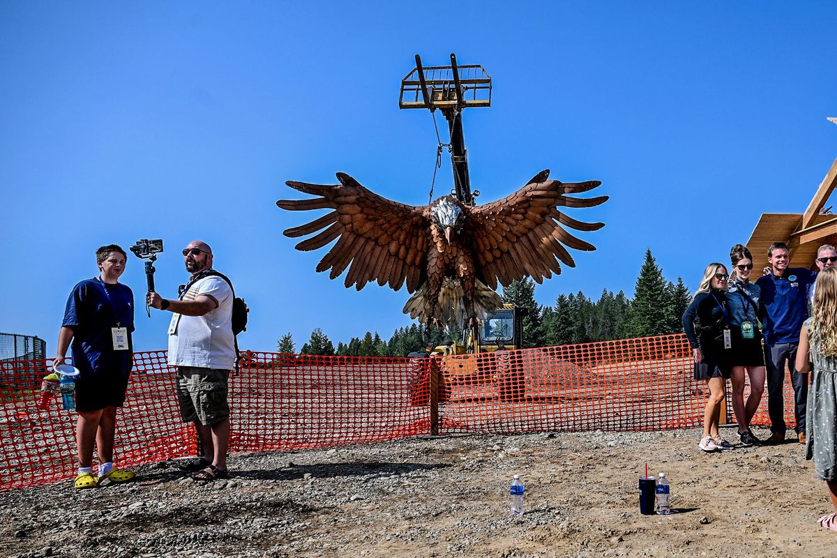 Folks gather Thursday before a giant eagle as it hangs over the future site of the Emerald Forest, a $15 million dollar project at Silverwood Theme Park in Athol.  (Kathy Plonka)