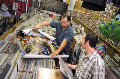 Brian Gilden, right, consults Recorded Memories owner Richard Terzieff  on Friday to buy the Michael Jackson album “Thriller.”  (CHRISTOPHER ANDERSON / The Spokesman-Review)