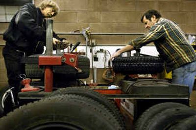 
Tire technician Ron Morton, left, and Buck's Tire and Automotive owner Buck Roma kept busy at the shop Tuesday as drivers made late-minute preparations for holiday travel.
 (Holly Pickett / The Spokesman-Review)