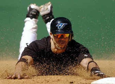 The Houston Astros are cracking down on head-first slides, like this one by Toronto's Bobby Estalella.
(Associated Press / The Spokesman-Review)