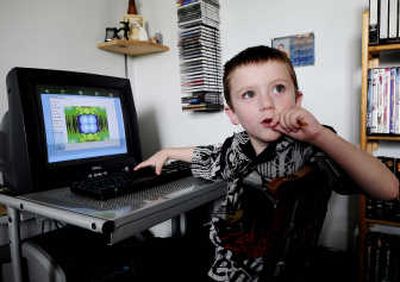 
Six-year-old Zackary Villeneuve uses the Zac Browser, which was developed for use by children with autism, at his home Sunday in Saint Remi, Quebec. Associated Press
 (Associated Press / The Spokesman-Review)