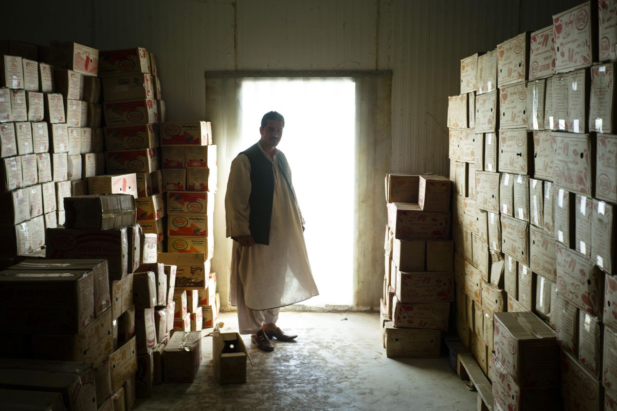 Rohollah Noori in 2015 in the refrigeration area of the Kandahar ice cream company he manages. The lack of electricity proved a challenge for his business. (Lorenzo Tugnoli / For The Washington Post)