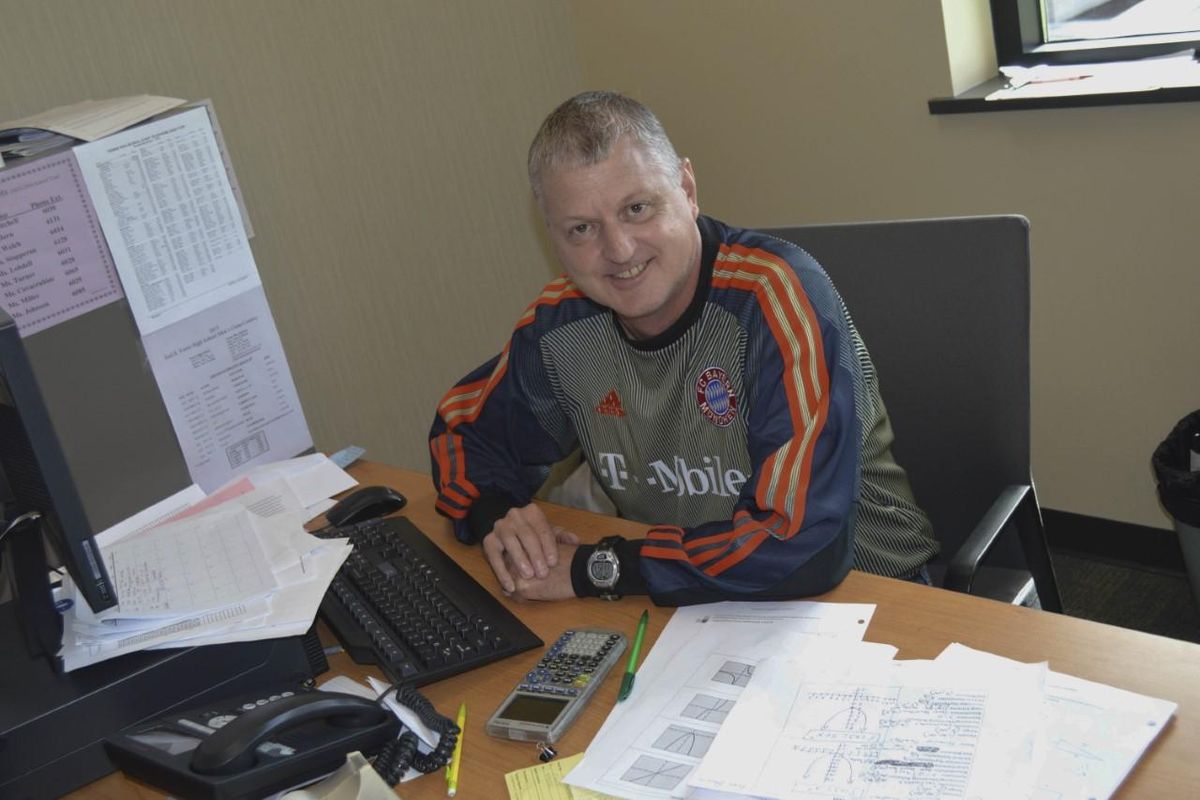 Chris Caviness, the boys cross country and girls track and field coach at Ferris, at his desk at the high school. Caviness died from cancer on Monday at 56. (Ferris athletics / Courtesy)