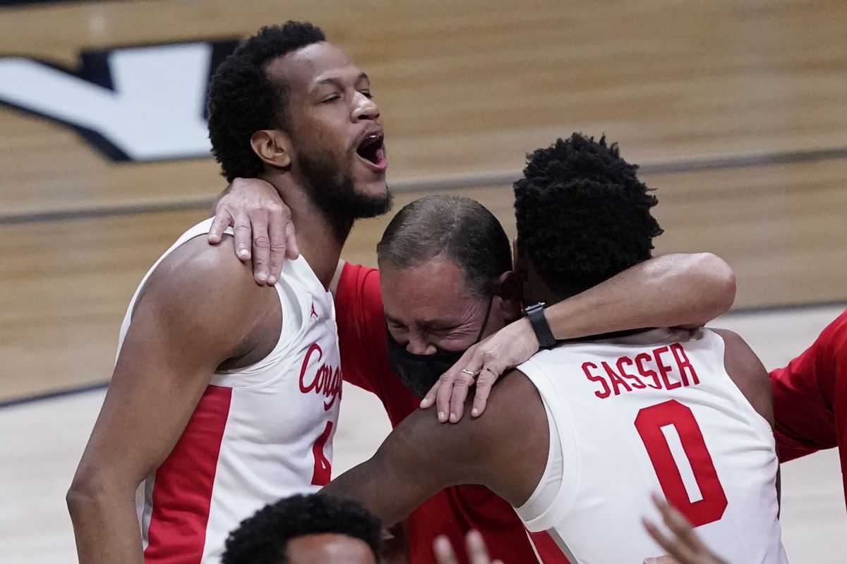 Houston’s Justin Gorham, head coach Kelvin Sampson and Marcus Sasser, left to right, celebrate after the Cougars defeated Oregon State during an Elite Eight game Monday in Indianapolis.  (Associated Press)