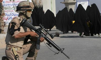 An Iraqi soldier provides security as Shiite women arrive for a major religious festival in Karbala, Iraq, Thursday. The Shabaniyah festival marks the birth of Mohammed al-Mahdi.  (Associated Press / The Spokesman-Review)