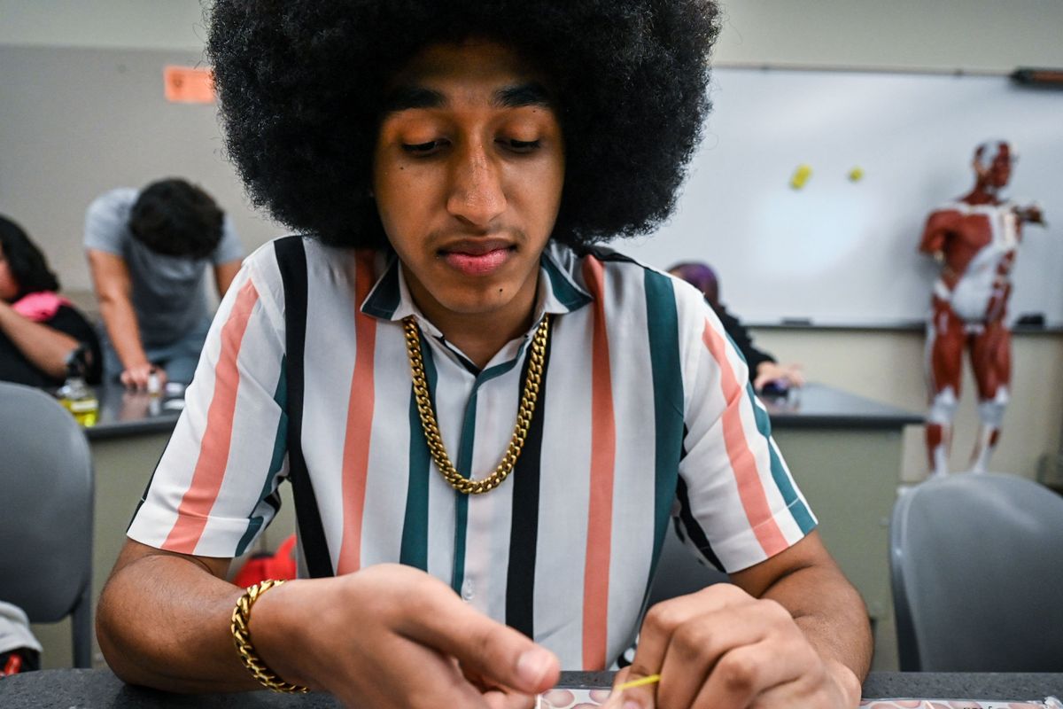 Dontae LaMere offers up his finger for a needle prick during a human health analysis class Wednesday at Spokane Falls Community College.  (DAN PELLE/THE SPOKESMAN-REVIEW)