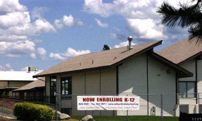 
A sign announcing enrollment is displayed in front of Valley Christian School. 
 (Liz Kishimoto / The Spokesman-Review)