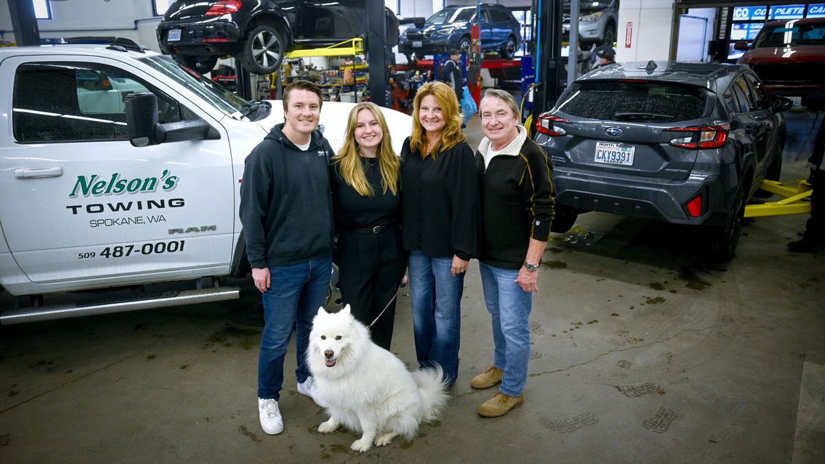 The Nelson family, from left, Nick, Alexis, Liz, Curtis and dog Laika stand for a photo on April 22 at Nelson’s Towing, Autobody & Repair in Spokane.  (Kathy Plonka/The Spokesman-Review)