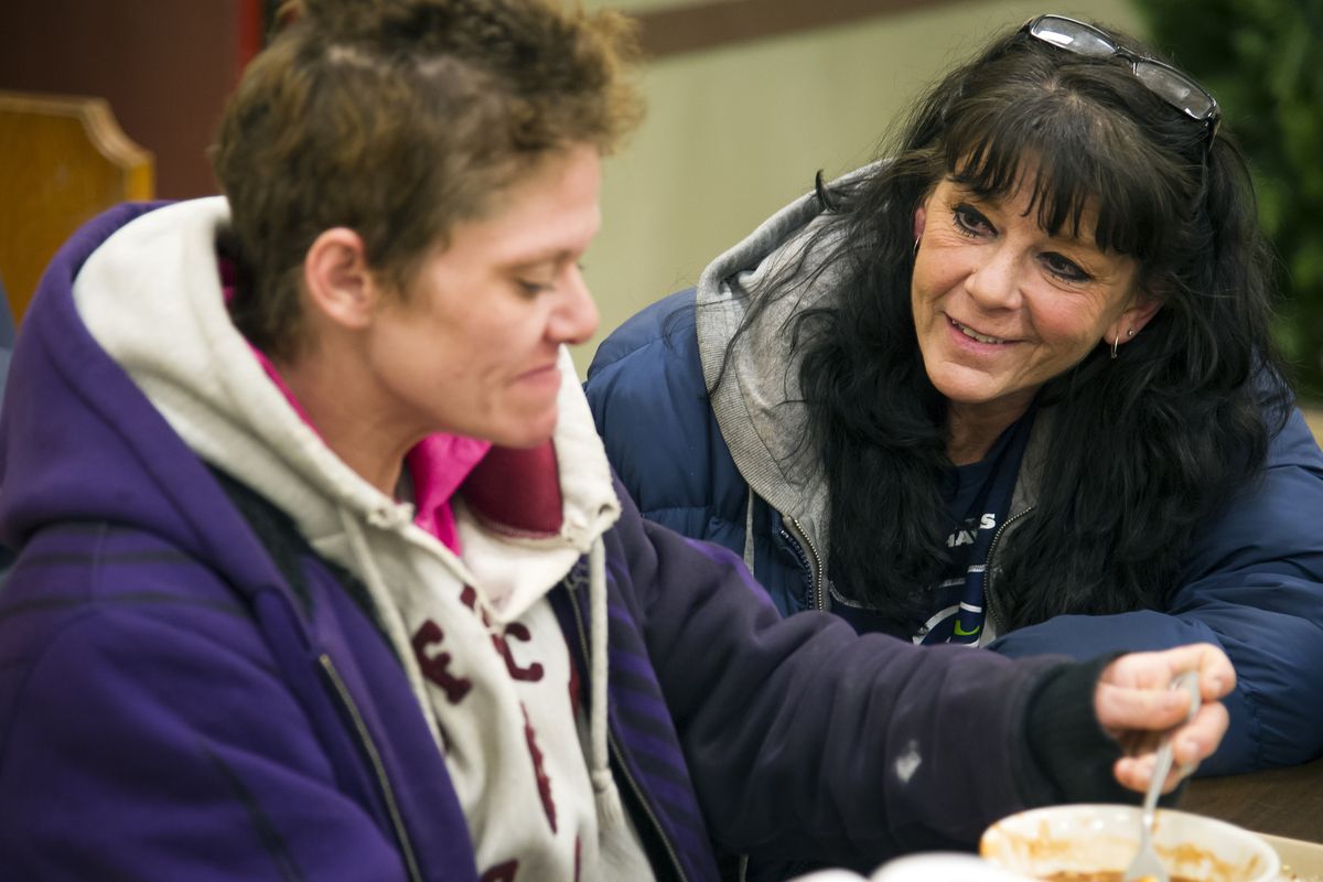 Patti McNabb, right, a Shalom Ministries volunteer, visits with Carrie Adams, who was eating a free dinner Monday in the basement of Central United Methodist Church. Shalom Ministries has received a grant to start Shalom Pathways Program. The goals are to provide job training, temporary housing and a job within the Shalom Ministries program to help the homeless get on their feet and off the streets. (Colin Mulvany)