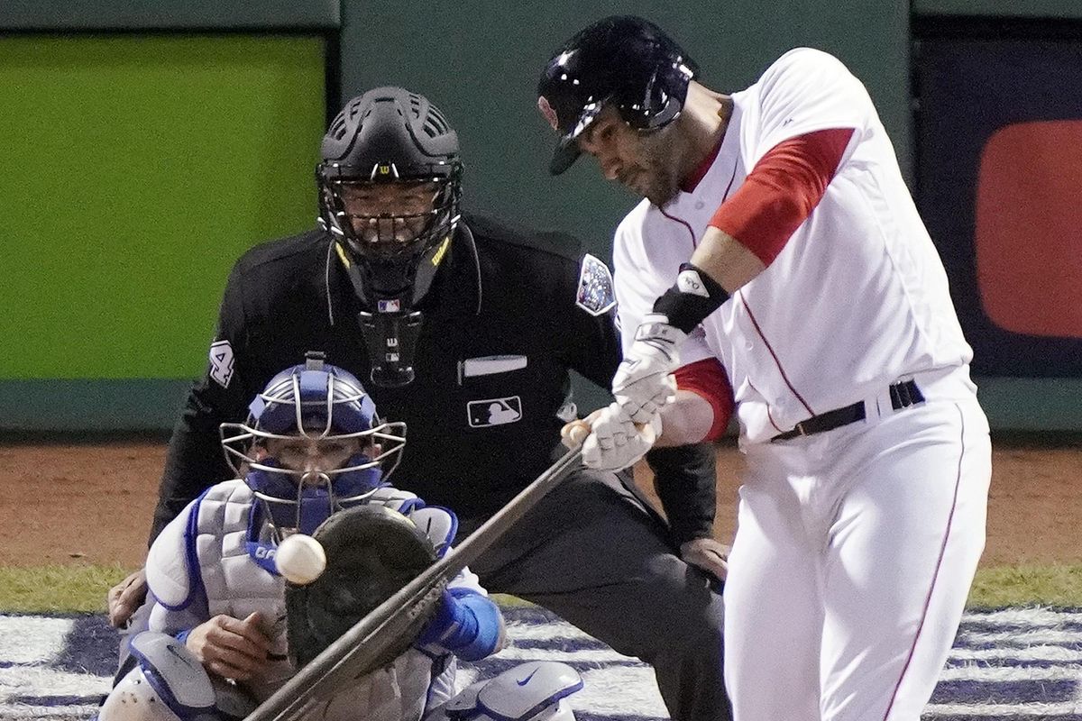 Boston Red Sox designated hitter J.D. Martinez hits a single to drive in two runs against the Los Angeles Dodgers during the fifth inning in Game 2 of the World Series baseball game, Wednesday, Oct. 24, 2018, in Boston. (Elise Amendola / Associated Press)
