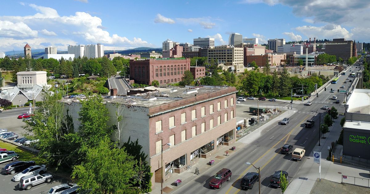 2018: Seen from North Monroe Street around College Avenue, the downtown buildings and their architecture reflect many different eras, dating from the late 1800s to the modern era. The photo is framed by the Riverfront Park clocktower, far left, from the site of the 1902 Great Northern Railroad Depot, which was torn down for Expo ’74, and the 1891 Review Tower building at far right. (Jesse Tinsley / The Spokesman-Review)