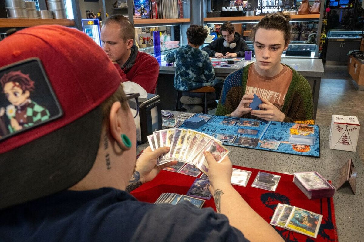 Connor Labrot, in hat, and Lucas Ryder play a One Piece trading card game at Sage’s Portal on Feb. 18. The One Piece card game is a fast-paced, two-player competitive trading card game released by Bandai in 2022 to celebrate the 25th anniversary of the franchise.  (Colin Mulvany / The Spokesman-Review)