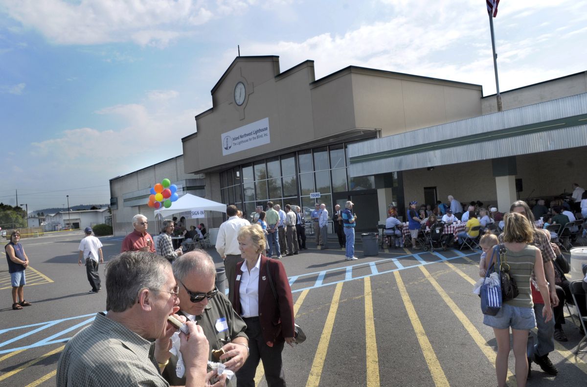 A crowd of spectators, employees and well wishers enjoy music and barbecue at the new Inland Northwest Lighthouse in north Spokane. (Photos by Christopher Anderson / The Spokesman-Review)