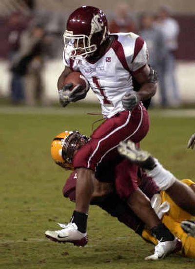 
Washington State running back Jerome Harrison runs over Arizona State middle linebacker Justin Burks in the second quarter Saturday, 
 (Associated Press / The Spokesman-Review)