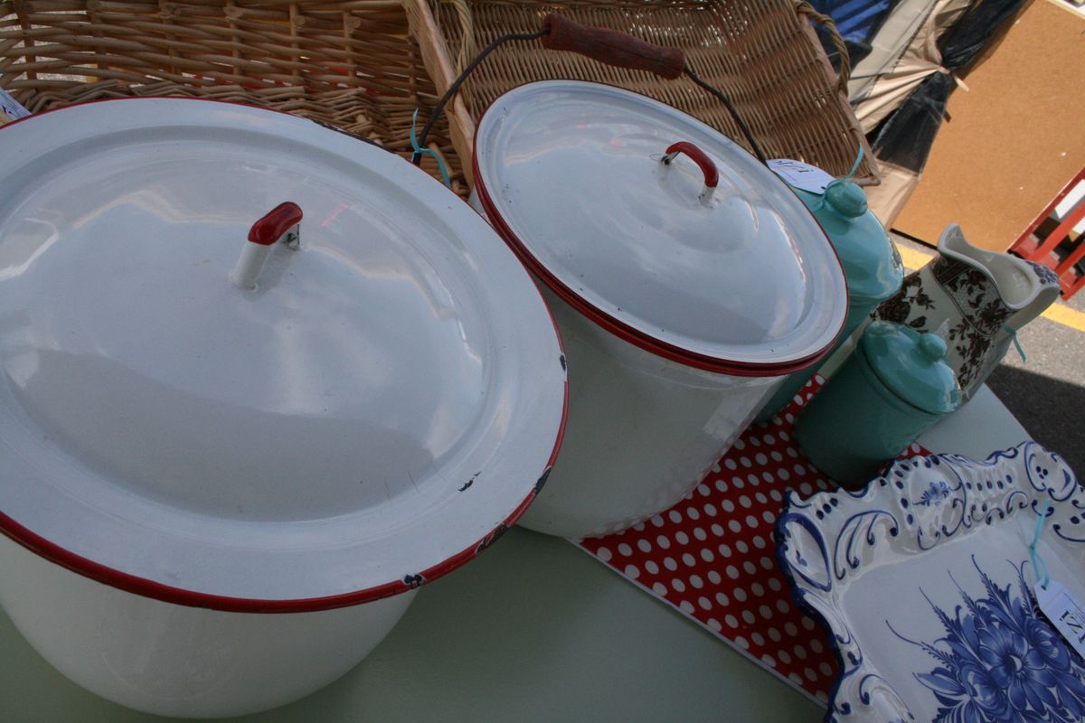 Red and white vintage enamelware next to aqua-colored canisters make for a punchy display in a booth run by Bizi Furniture Etc. at the Latah Creek Variety Market. The event runs June 20 and 21, 2009. (www.thebizishop.com; 208-691-9997) (Megan Cooley / The Spokesman-Review)