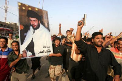 
Iraqis carry posters of cleric Muqtada al-Sadr on Tuesday after U.S. troops dismantled checkpoints around Baghdad's Shiite enclave of Sadr City after orders from  Iraq's prime minister. 
 (Associated Press / The Spokesman-Review)