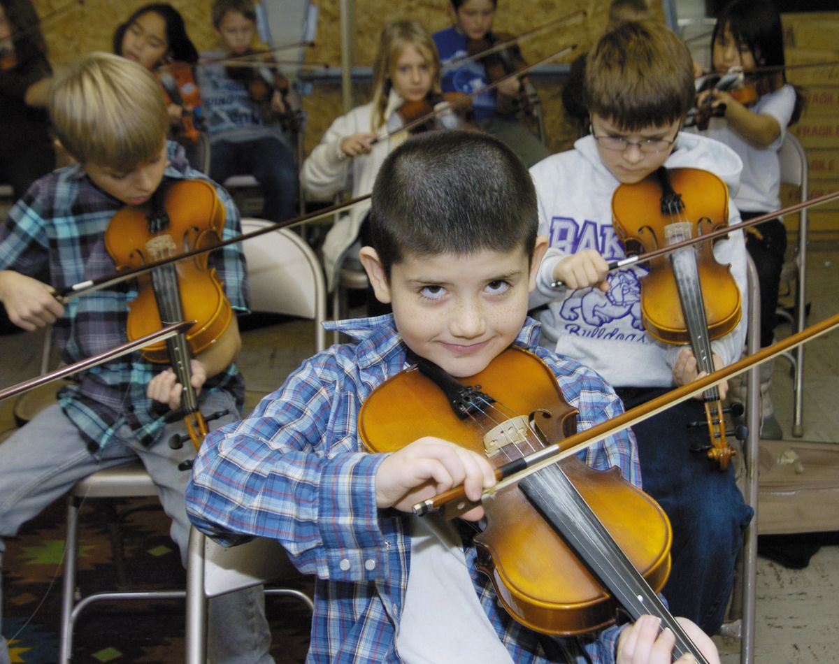 Clay Hickman smiles during a fiddling warm-up session last week at Brooklyn Primary School  in  Baker City, Ore.  (Associated Press)