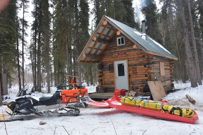 Snowmobilers Josh Rindal and Bob Jones take refuge in the Carlson's Crossing Cabin during their 1,400-mile Alaska journey following the trail of the 2014 Iditarod Sled Dog Race.  (Robert Jones)