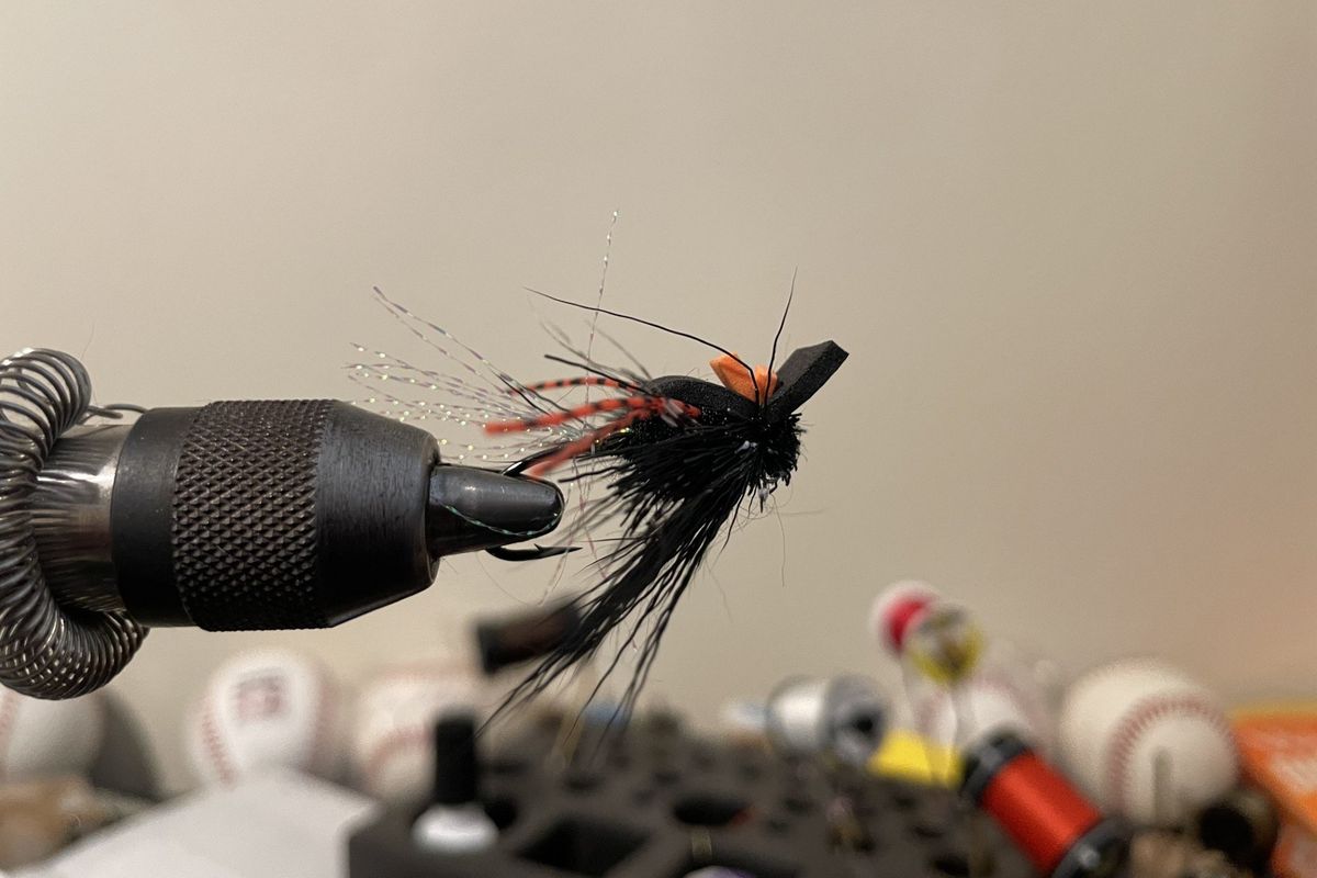 A steelhead dry fly made of black deer hair, black foam, flash and rubber legs.  (Michael Wright/The Spokesman-Review)