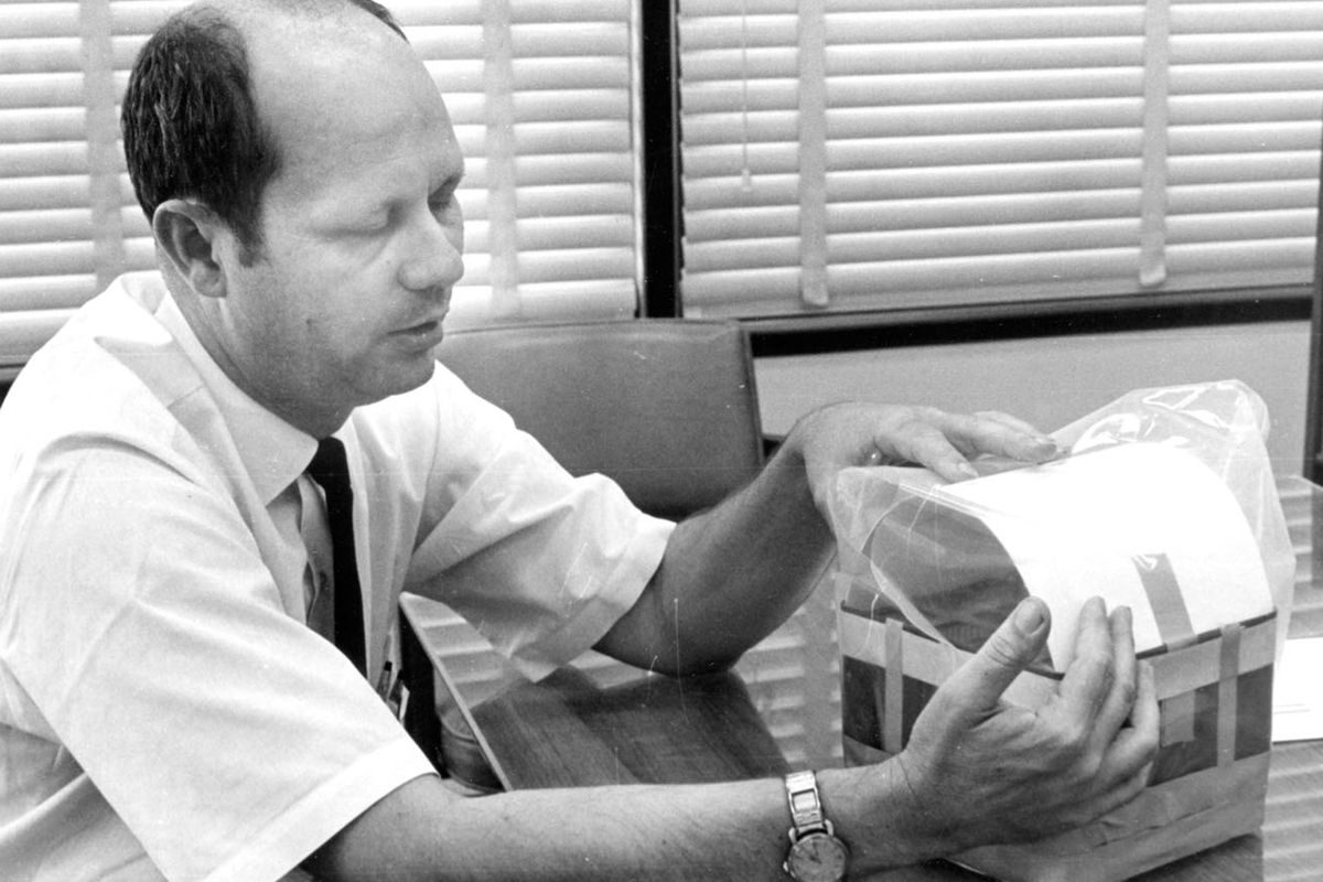 Ed Smylie simulates the filter that he and his colleagues fashioned for the Apollo 13 astronauts in 1970. (Mississippi State University Libraries)