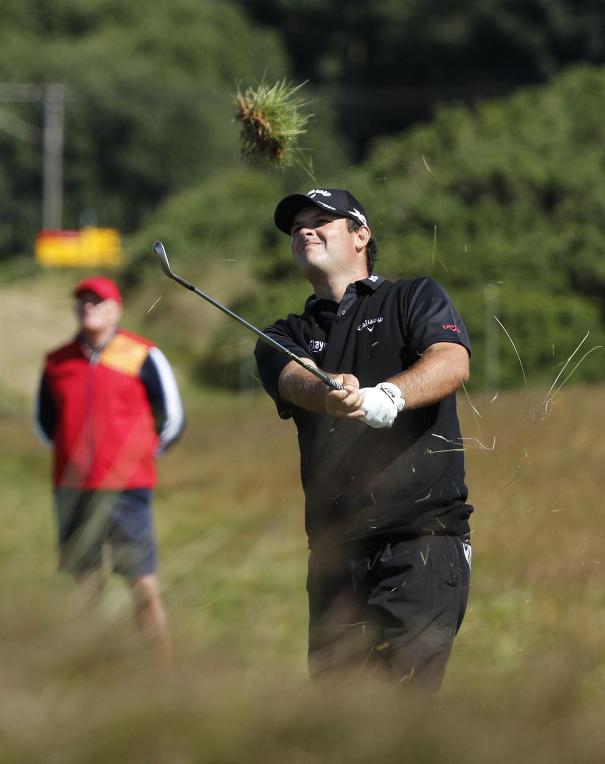 Patrick Reed of the U.S. plays out of the heavy rough on the 12th fairway during the first round of the British Open Golf Championship at the Royal Troon Golf Club in Troon, Scotland on Thursday. (Ben Curtis / Associated Press)