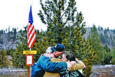 
From left, Kenny Van Slyke's brother Daniel Van Slyke, 23; his father, Keith Van Slyke; his brother Taylor Van Slyke, 15; and his stepmother, Trish Van Slyke, hug Saturday after flying a flag at half-staff for him near their Spokane County home. 
 (Jed Conklin / The Spokesman-Review)