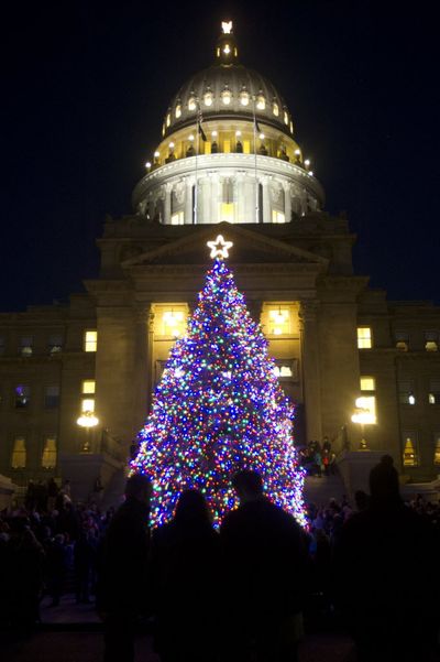A crowd, including Santa, enthusiastically helped Gov. Butch Otter and First Lady Lori Otter with the countdown to light Idaho's Capitol Christmas Tree on Monday. The 39-foot blue spruce was donated by Al and Jean Day from Boise's North End — it was 8 feet tall when it was planted in 1997. Afterwards, festivities continued in the Rotunda with music by the 25th Army Band, free books and toothbrushes for children, and 3,000 sugar cookies decorated with the State Seal. (Katherine Jones/Idaho Statesman via AP)